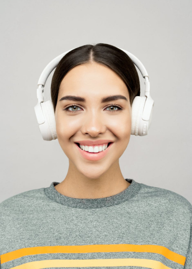 A woman with a headset on, smiling.